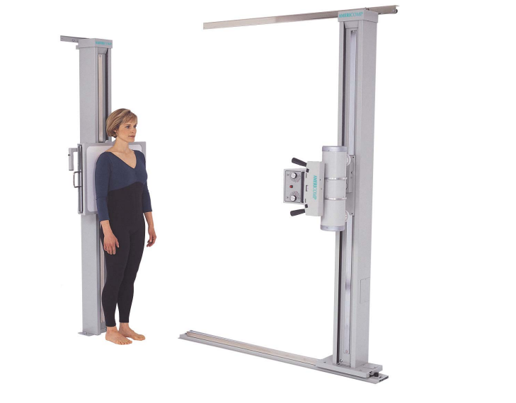 A picture of the woman standing at the digital imaging machine